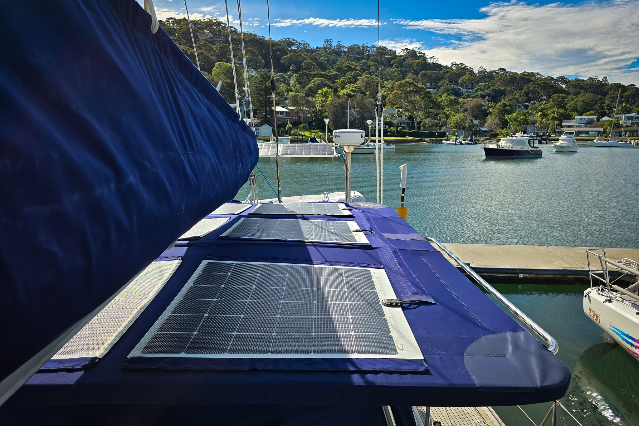 Solar panels attached to bimini navy blue on sailing yacht