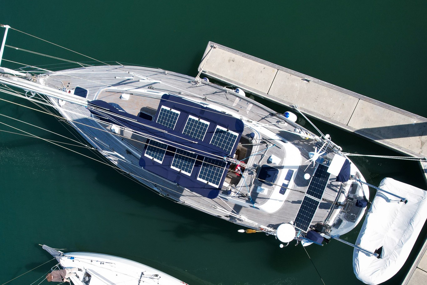 6flexible solar panels attached to blue bimini on a sailing boat - drone view