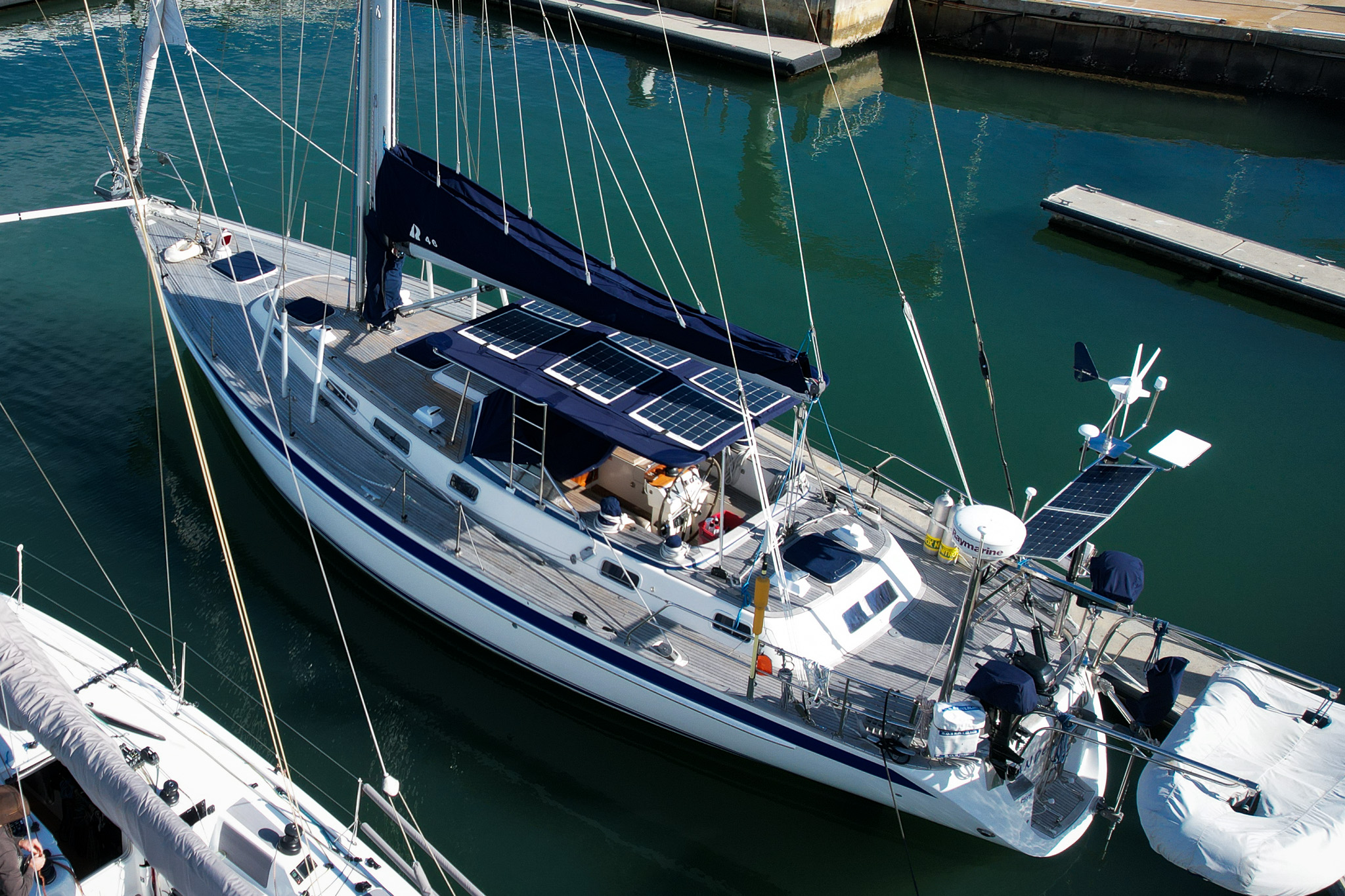 Solar panels attached to bimini navy blue on sailing yacht drone view