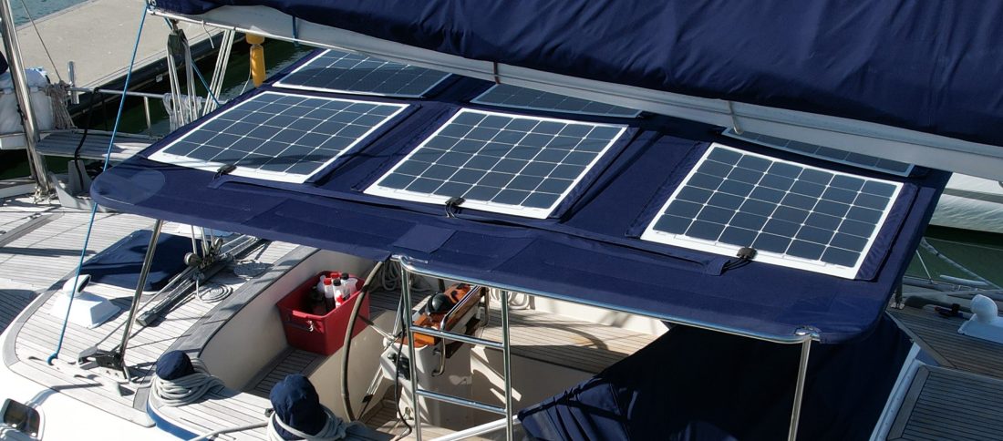 3 flexible solar panels attached to blue bimini on a sailing boat