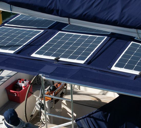 3 flexible solar panels attached to blue bimini on a sailing boat