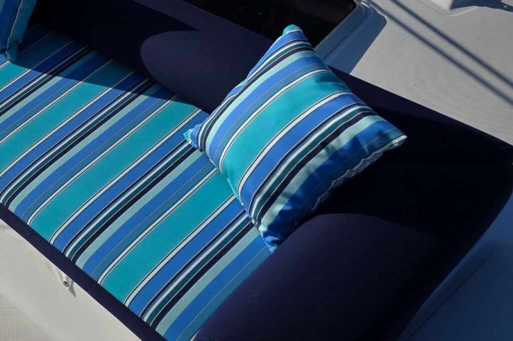 Seawind 1160 Sunbed – Sunbrella Dolce Oasis Custom Seawind 1160 sunbed in striped Sunbrella Dolce Oasis and Navy upholstery
